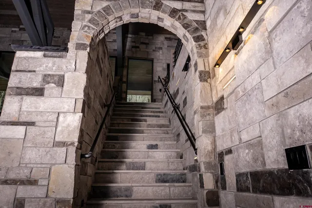 a living room with a bed and a dresser