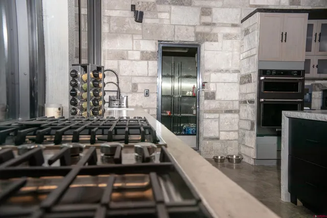 a kitchen with granite countertop a stove and a refrigerator