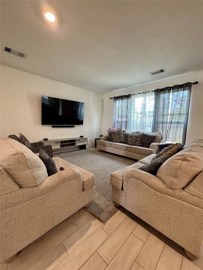 734 Hardwood Grv Court Houston, TX 77090 - Photo 11 of 23 a living room with furniture and a flat screen tv