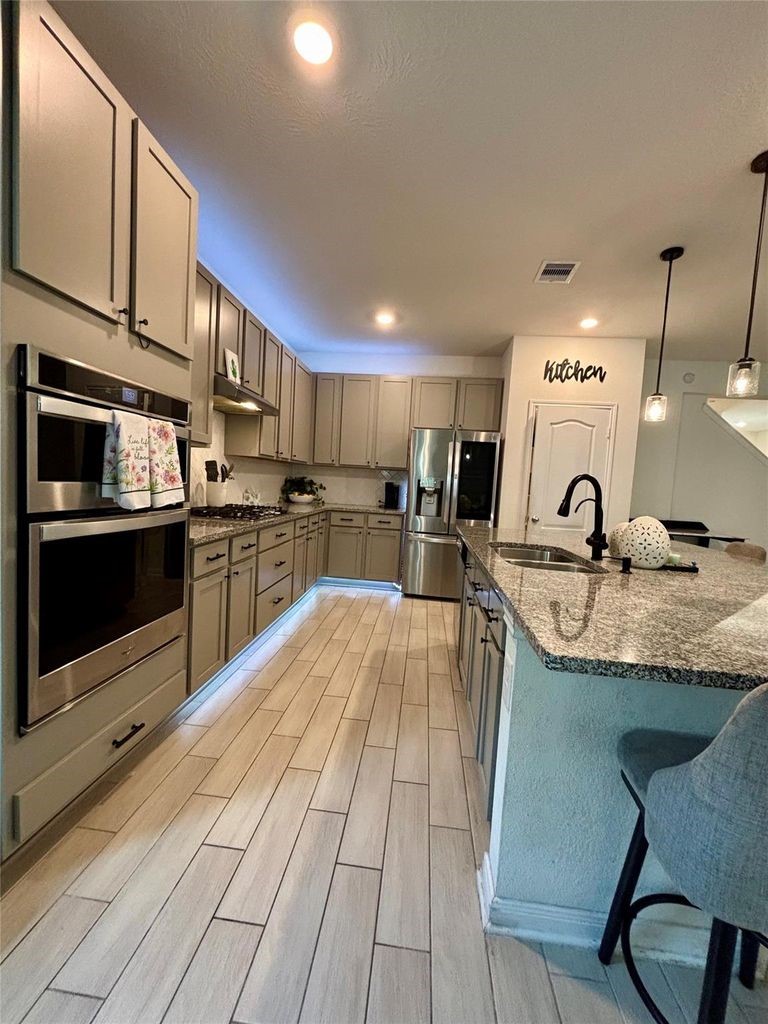 734 Hardwood Grv Court Houston, TX 77090 - Photo 12 of 23 a kitchen with stainless steel appliances granite countertop a sink and cabinets