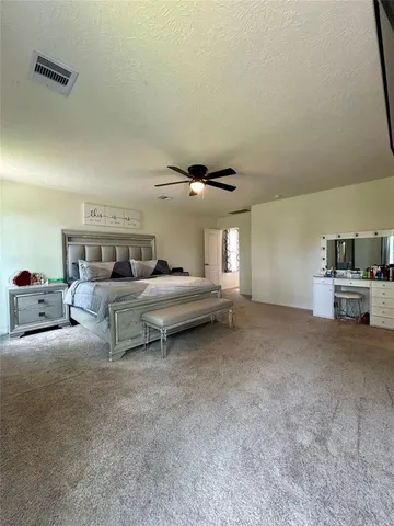 a bed room with furniture and a ceiling fan