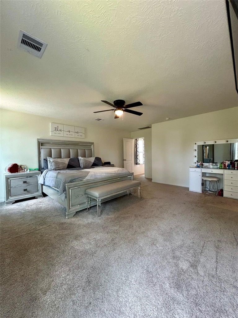 734 Hardwood Grv Court Houston, TX 77090 - Photo 15 of 23 a bed room with furniture and a ceiling fan