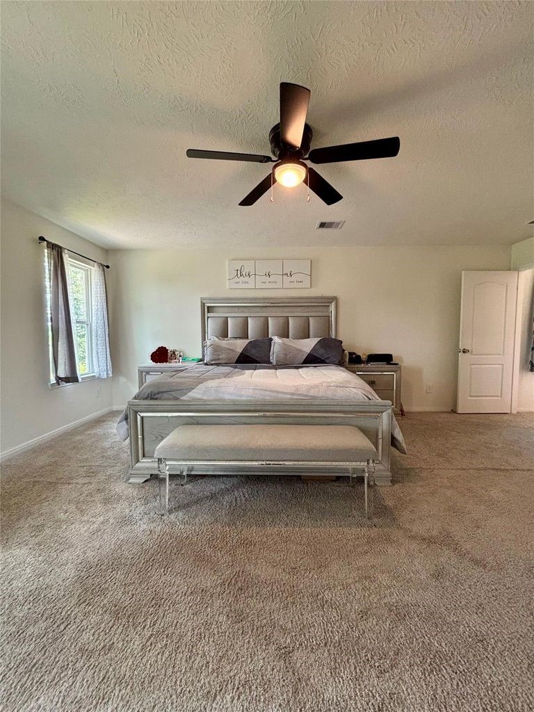 734 Hardwood Grv Court Houston, TX 77090 - Photo 17 of 23 a bedroom with a bed and a ceiling fan