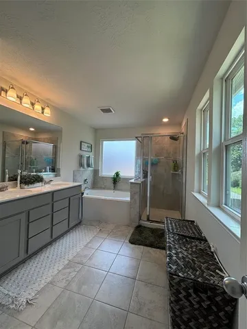 a large bathroom with a large tub and shower