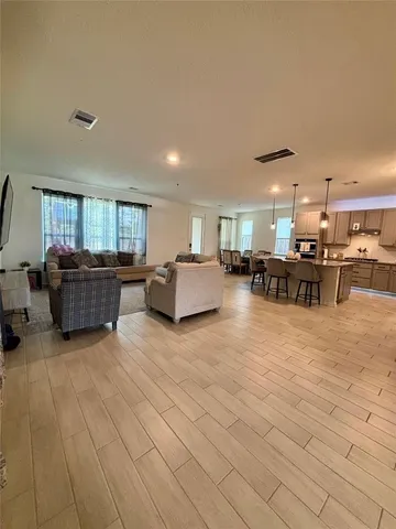 a living room with furniture and a kitchen