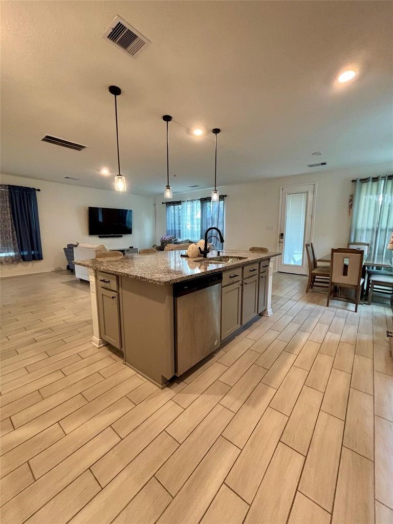 734 Hardwood Grv Court Houston, TX 77090 - Photo 9 of 23 a large kitchen with stainless steel appliances kitchen island granite countertop a sink and cabinets