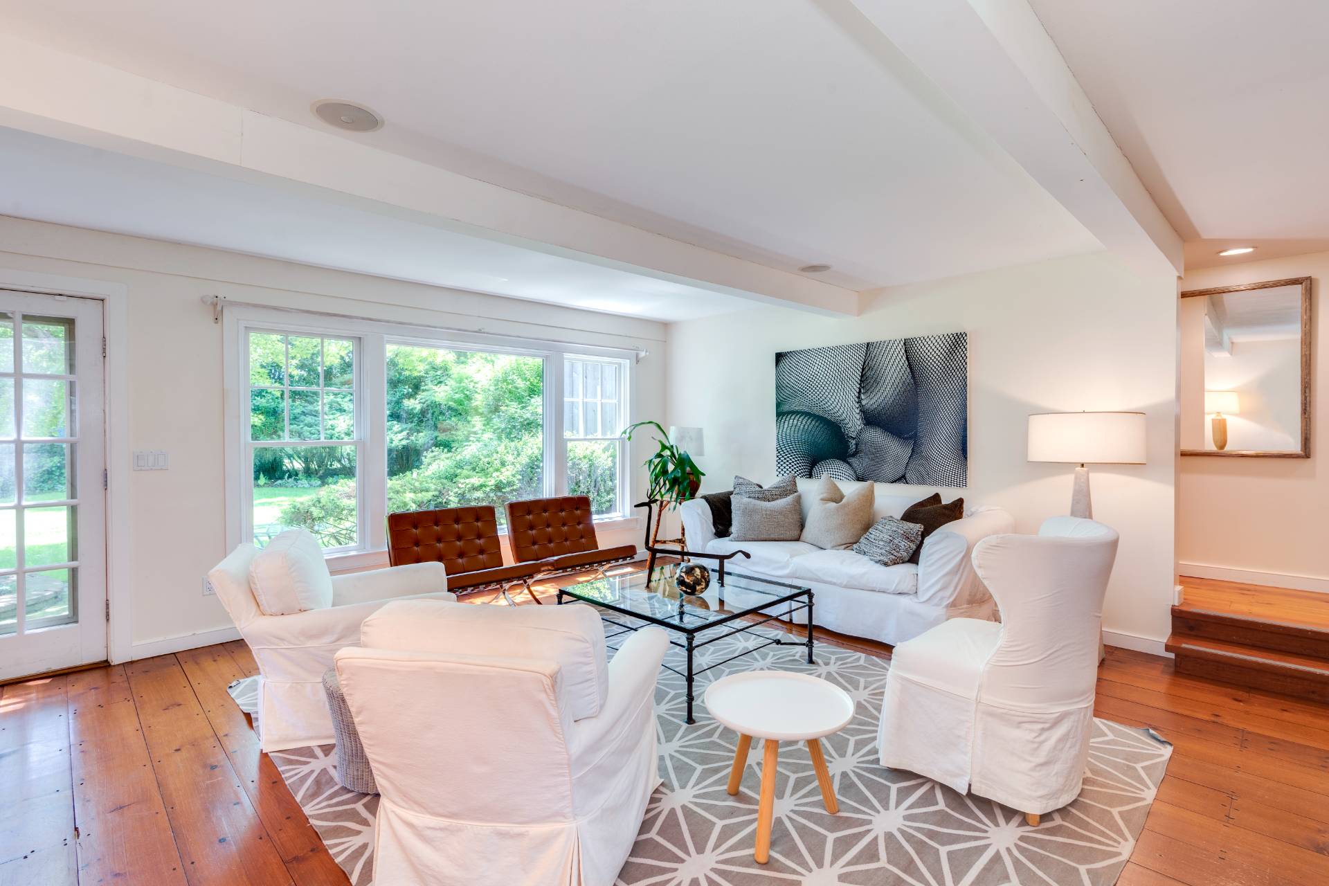53 Hildreth Lane Bridgehampton, NY 11932 - Photo 13 of 37 a living room with fireplace furniture and a large window