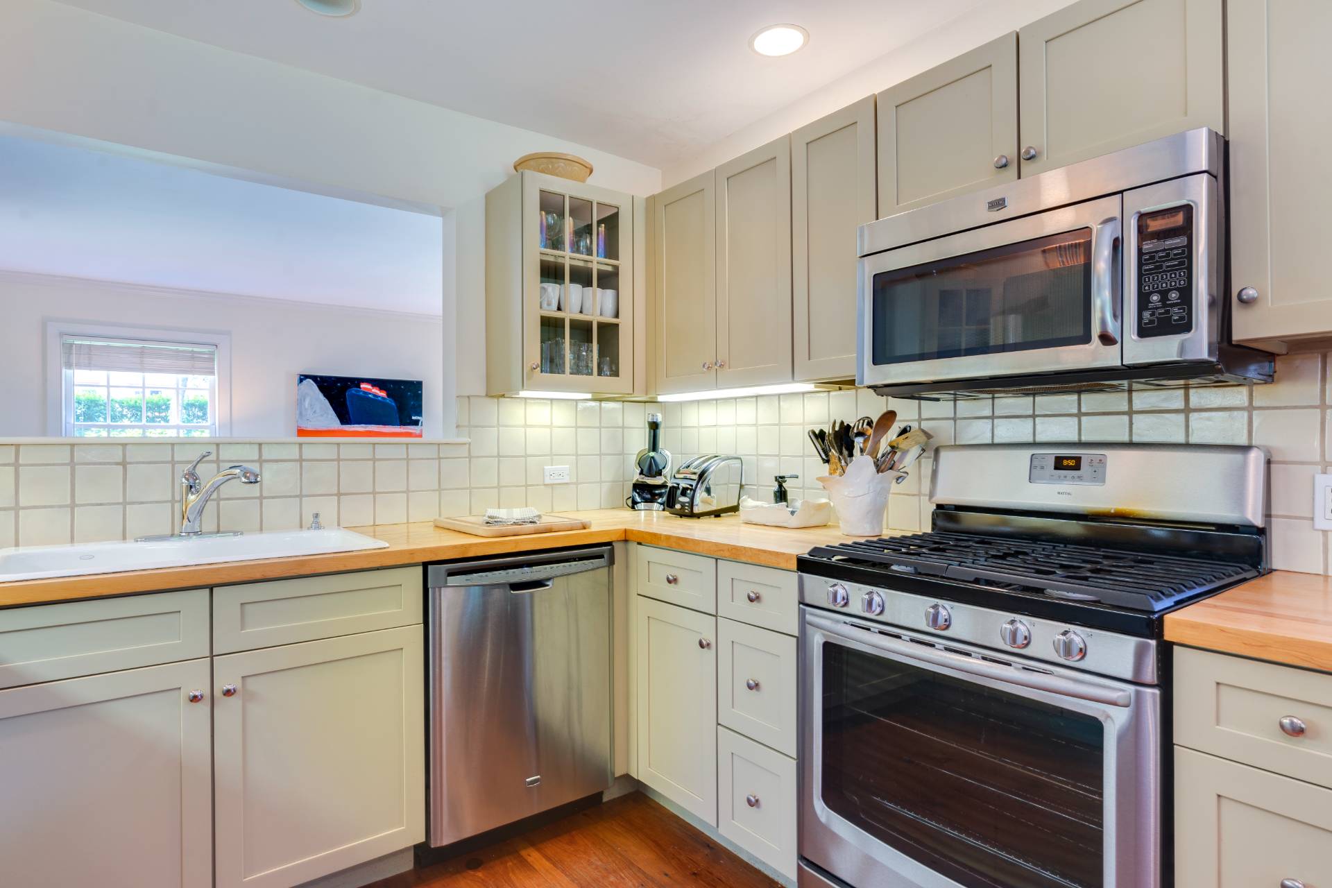 53 Hildreth Lane Bridgehampton, NY 11932 - Photo 18 of 37 a kitchen with stainless steel appliances a stove a sink and a microwave