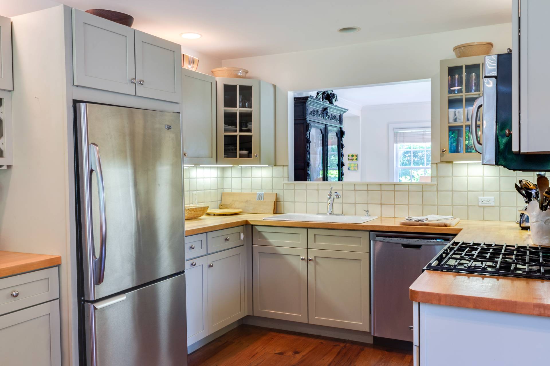 53 Hildreth Lane Bridgehampton, NY 11932 - Photo 19 of 37 a kitchen with stainless steel appliances a sink stove and refrigerator