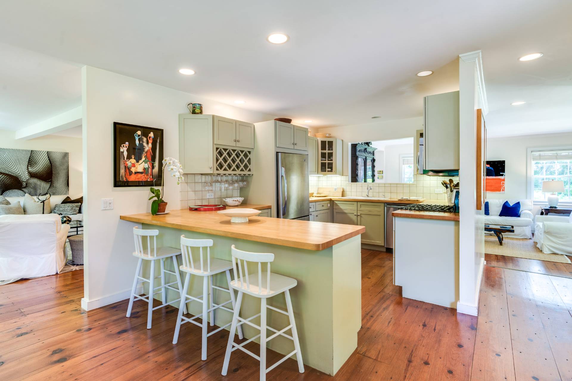53 Hildreth Lane Bridgehampton, NY 11932 - Photo 20 of 37 a kitchen with stainless steel appliances kitchen island granite countertop a table chairs and a refrigerator
