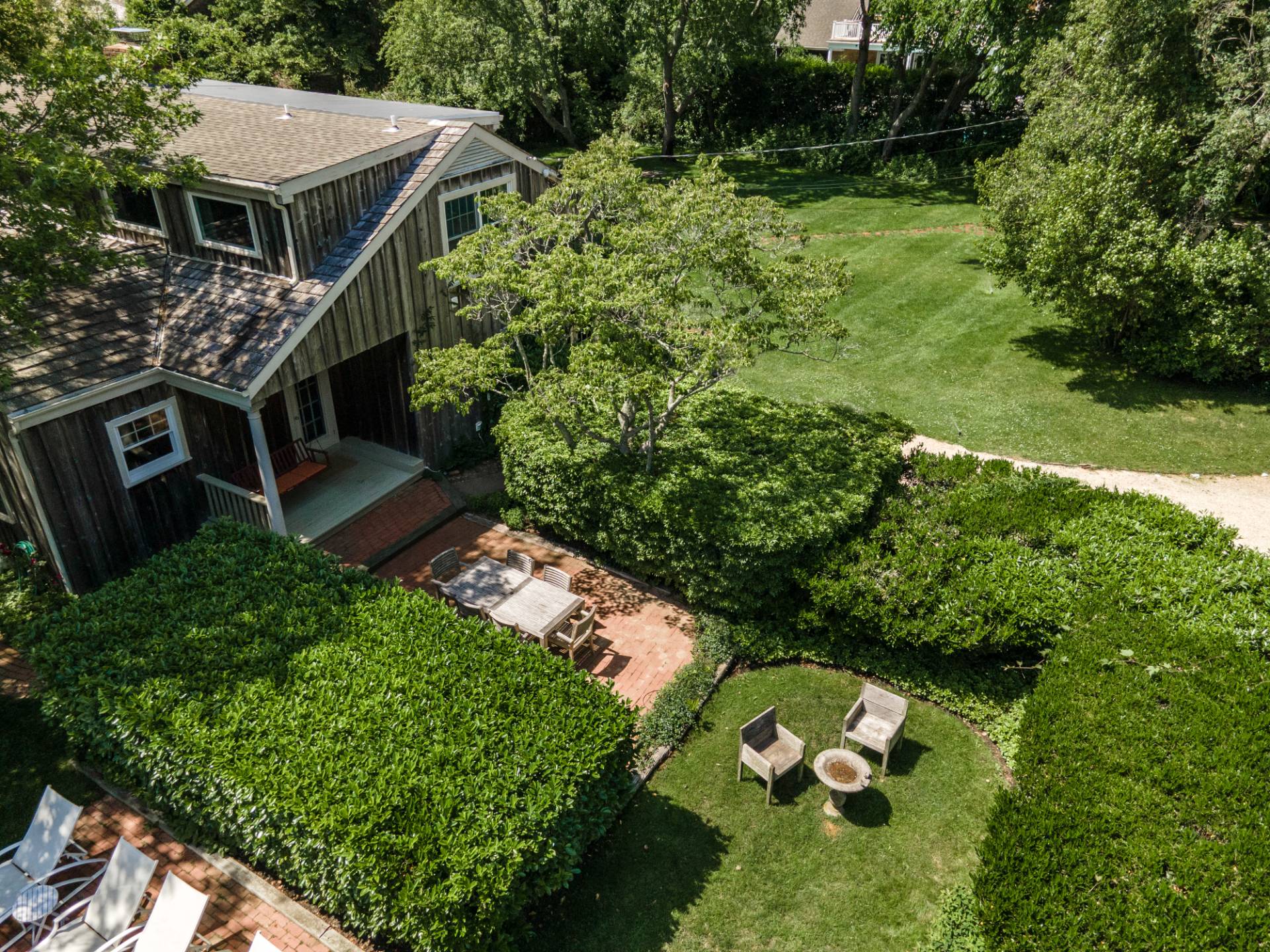 53 Hildreth Lane Bridgehampton, NY 11932 - Photo 10 of 37 a balcony with potted plants and large trees