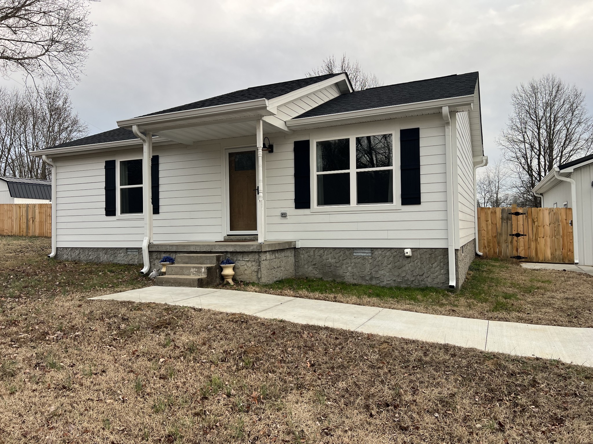 1343 Oaklawn Road Chapmansboro, TN 37035 - Photo 2 of 10 a front view of a house with two yard