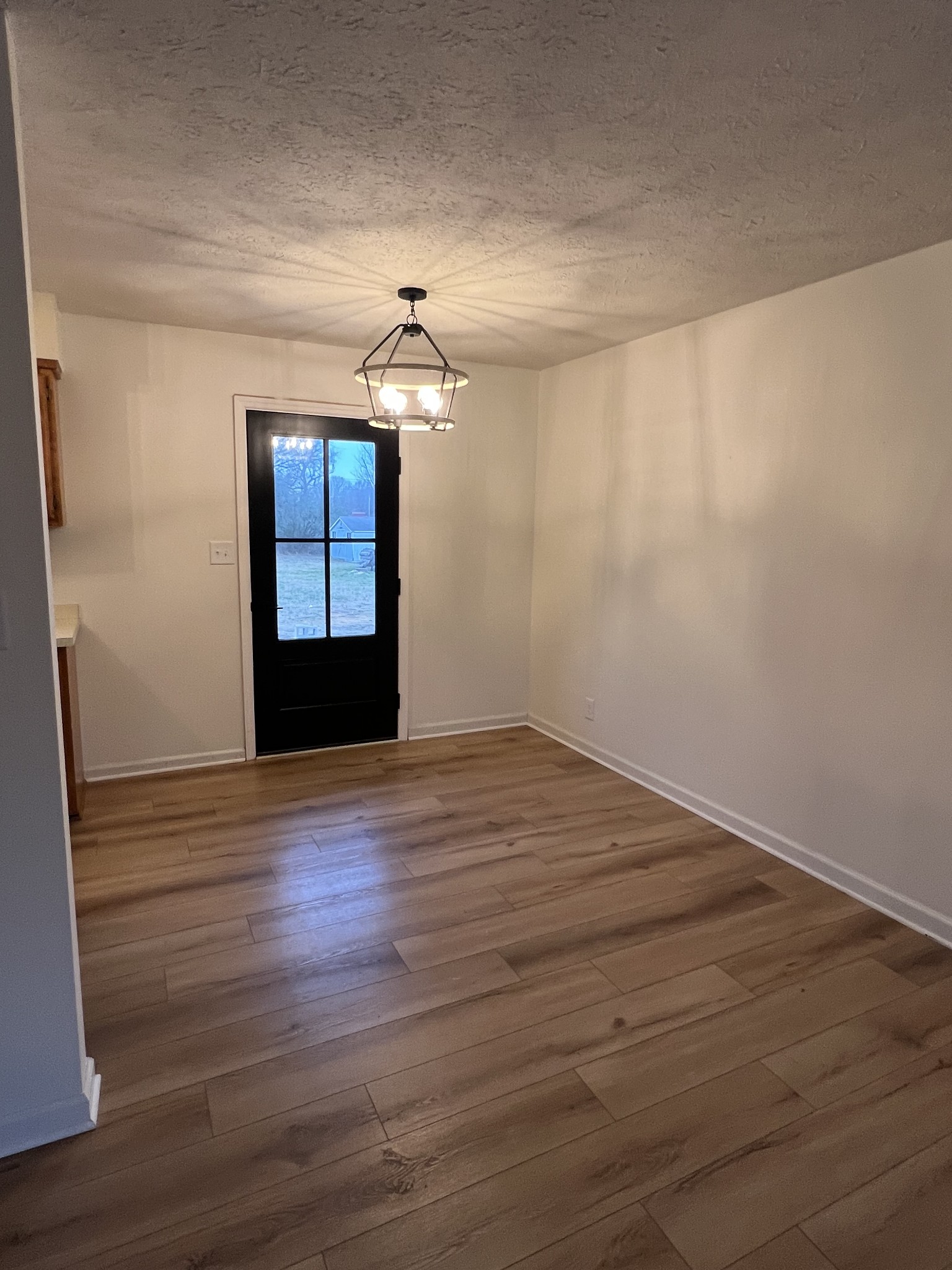 1343 Oaklawn Road Chapmansboro, TN 37035 - Photo 7 of 10 a view of empty room with wooden floor and fan