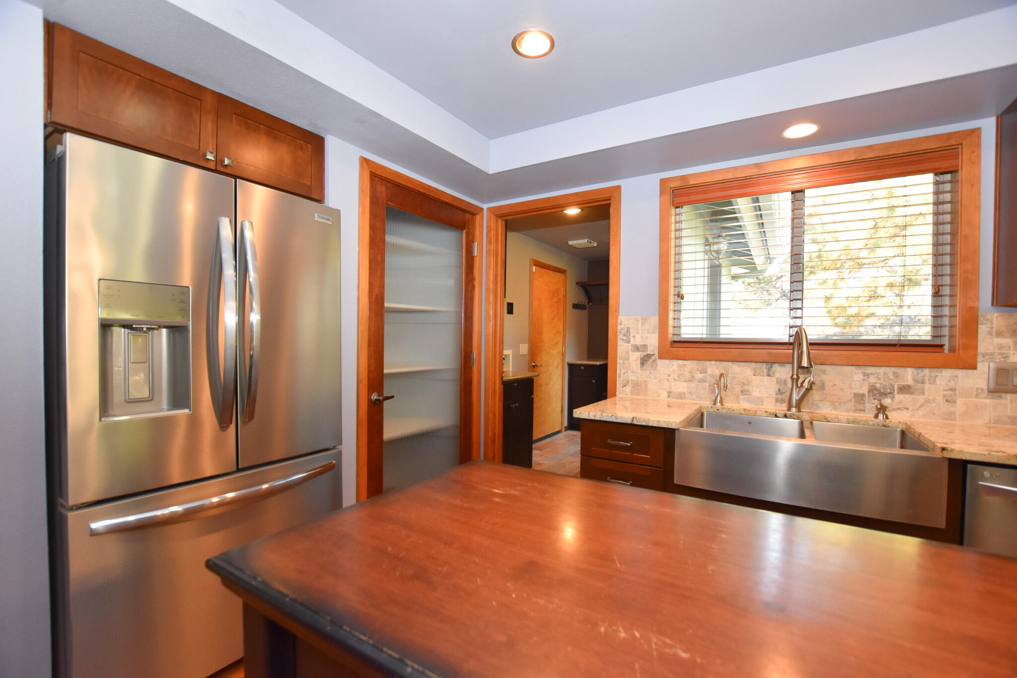 64730 Sylvan Loop Bend, OR 97701 - Photo 24 of 46 a large kitchen with stainless steel appliances granite countertop a refrigerator and a sink