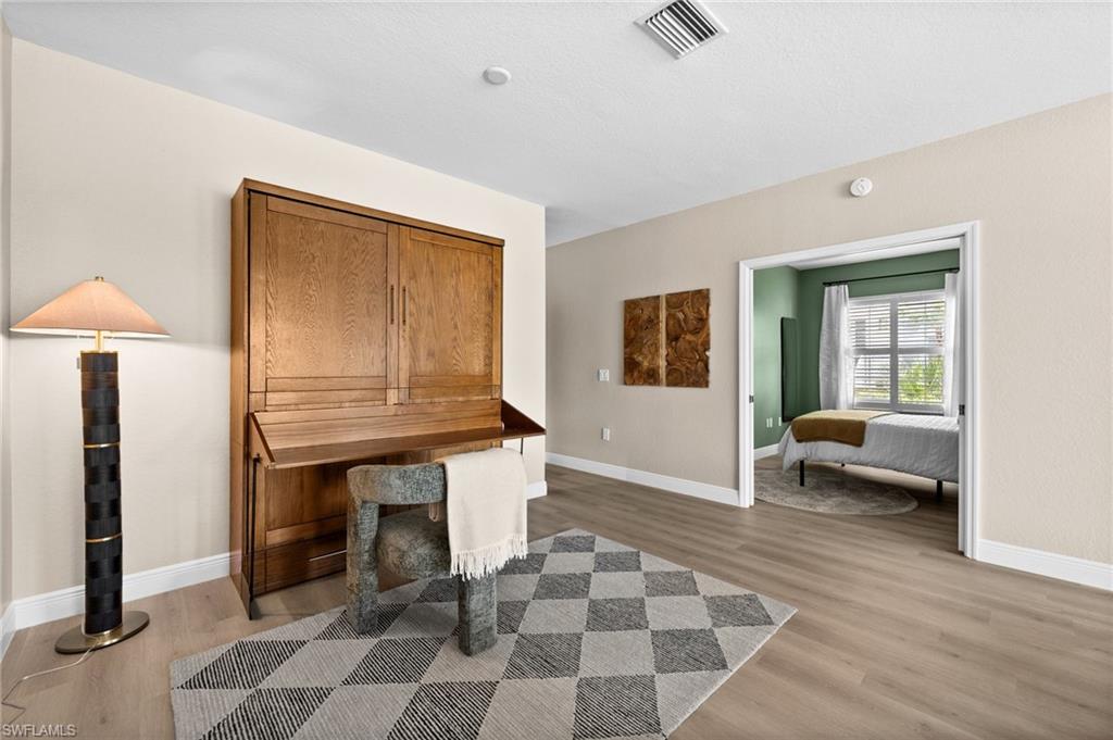 6080 Pinnacle Lane, Unit 1701 Naples, FL 34110 - Photo 16 of 39 a living room with furniture and a table