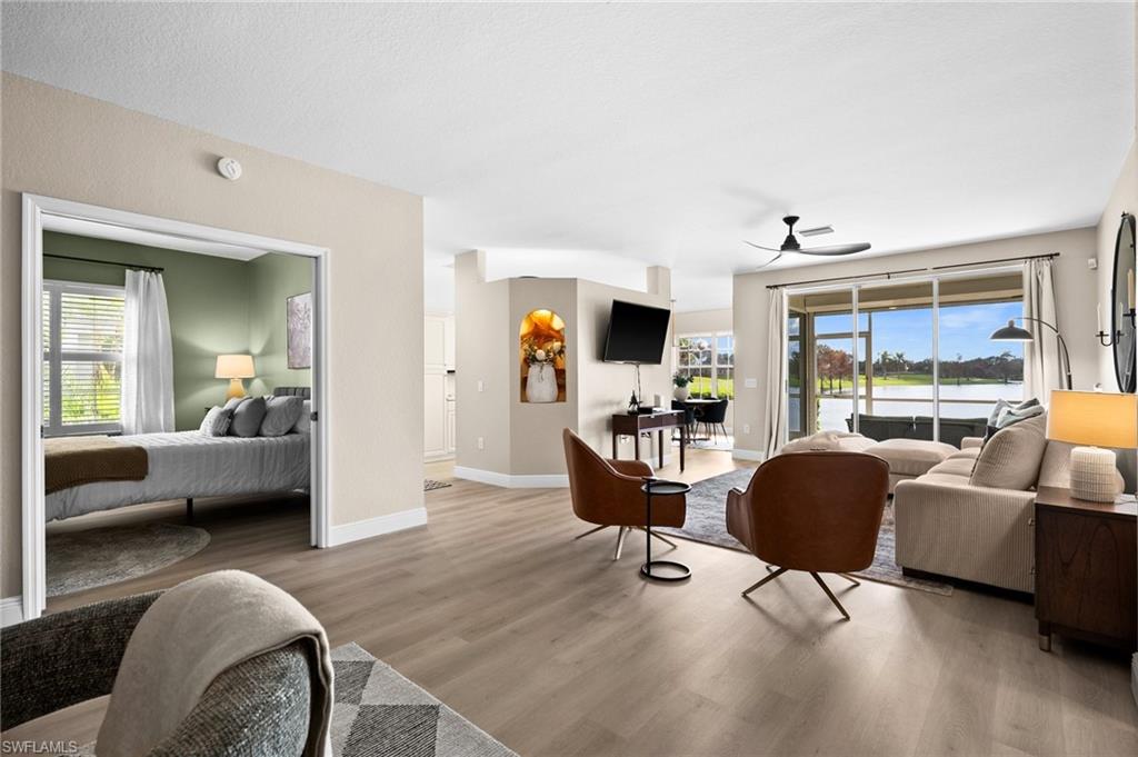 6080 Pinnacle Lane, Unit 1701 Naples, FL 34110 - Photo 17 of 39 a living room with furniture and a large window