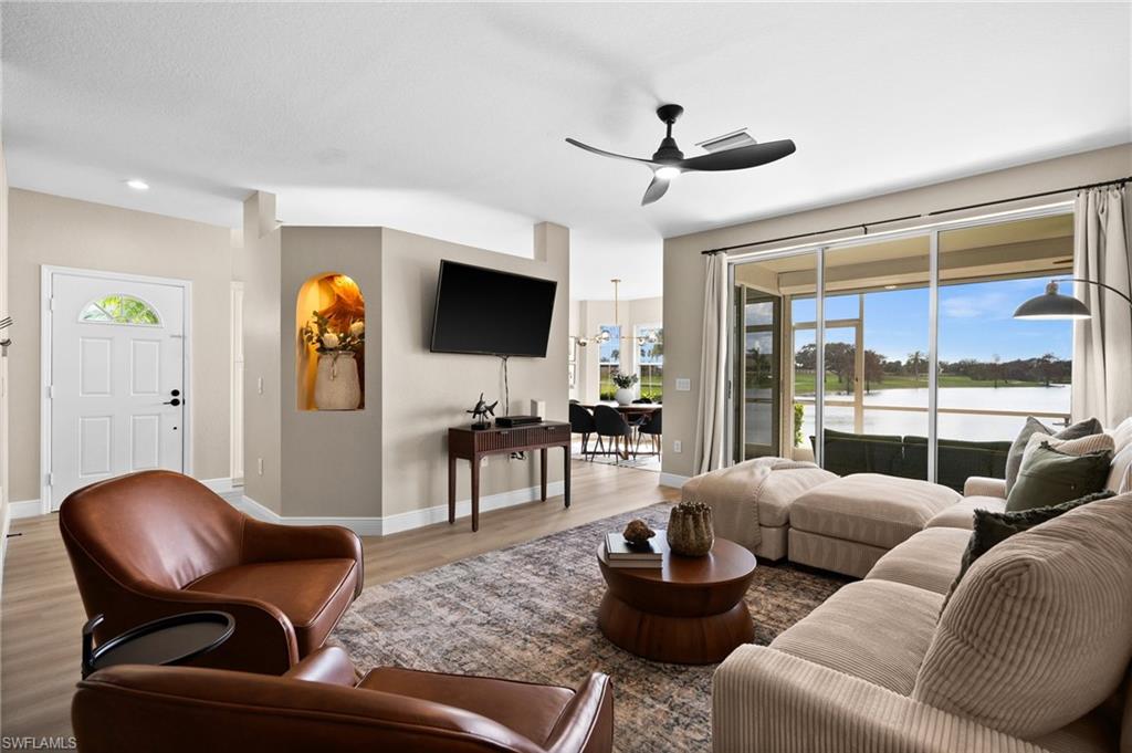 6080 Pinnacle Lane, Unit 1701 Naples, FL 34110 - Photo 19 of 39 a living room with furniture and a flat screen tv