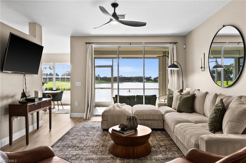6080 Pinnacle Lane, Unit 1701 Naples, FL 34110 - Photo 20 of 39 a living room with furniture and a flat screen tv