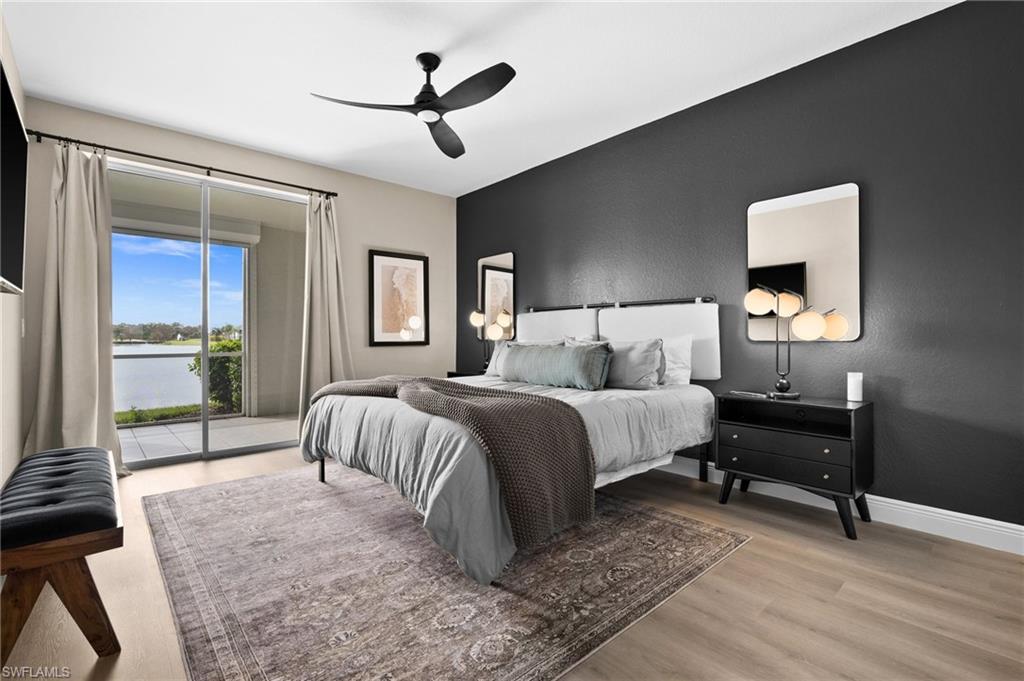6080 Pinnacle Lane, Unit 1701 Naples, FL 34110 - Photo 21 of 39 a bedroom with a bed and a chandelier