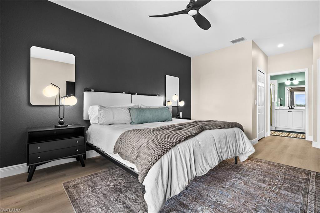 6080 Pinnacle Lane, Unit 1701 Naples, FL 34110 - Photo 22 of 39 a bedroom with a bed lamps and a dresser