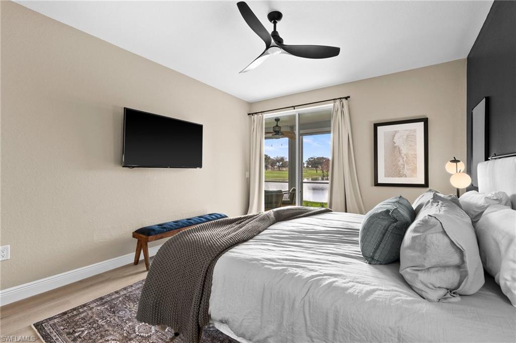 6080 Pinnacle Lane, Unit 1701 Naples, FL 34110 - Photo 23 of 39 a bedroom with a bed tv and a window