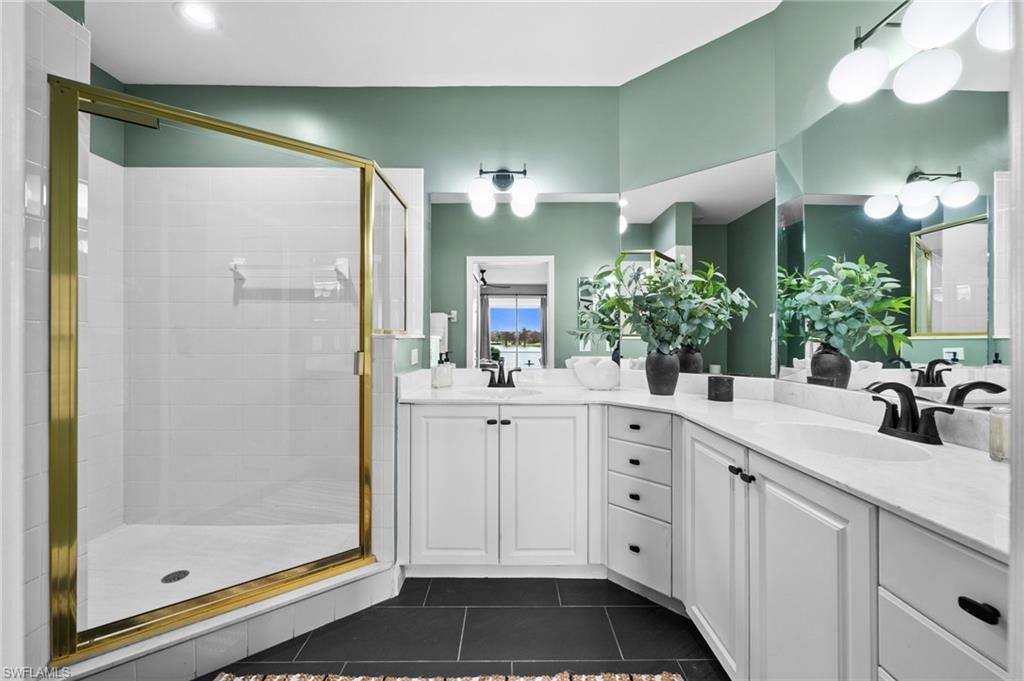 6080 Pinnacle Lane, Unit 1701 Naples, FL 34110 - Photo 24 of 39 a bathroom with a double vanity sink mirror and shower