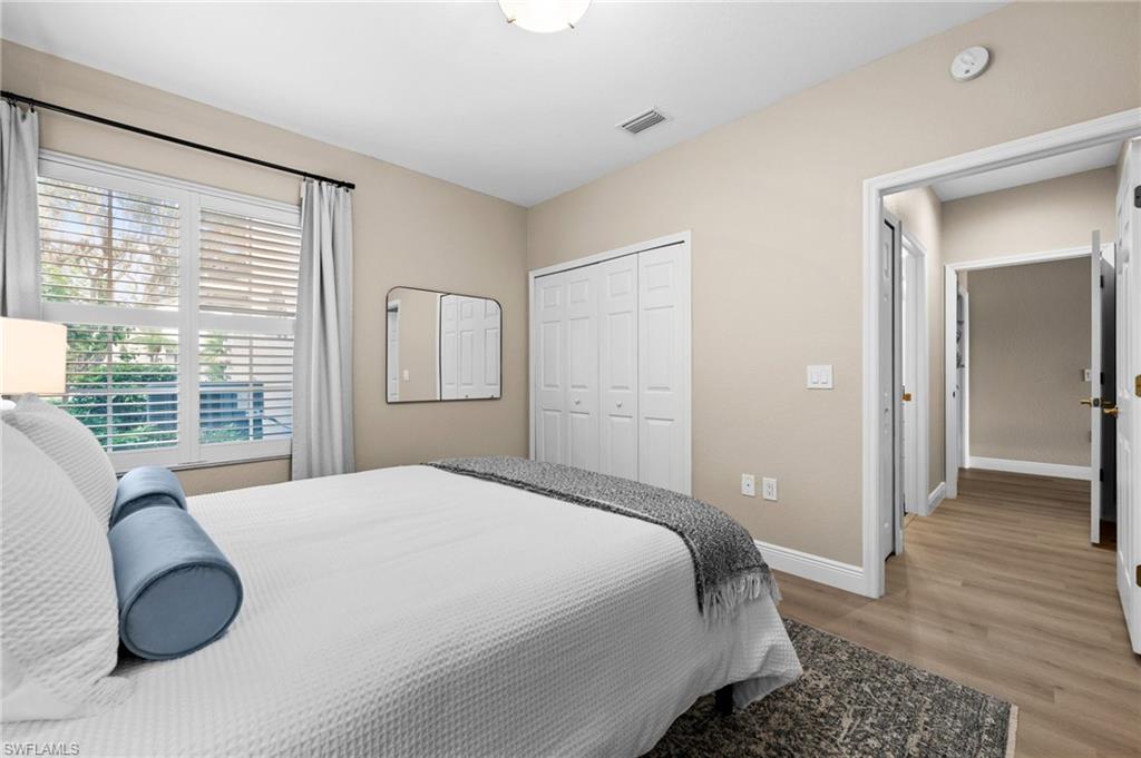 6080 Pinnacle Lane, Unit 1701 Naples, FL 34110 - Photo 27 of 39 a bedroom with a bed and a large window