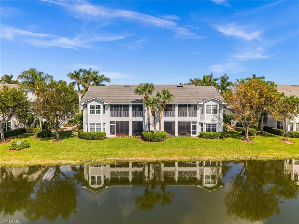 6080 Pinnacle Lane, Unit 1701 Naples, FL 34110 - Photo 36 of 39 a front view of a house with a yard