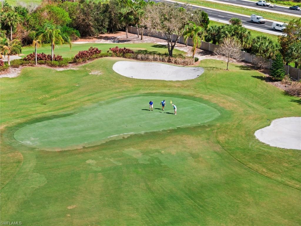 6080 Pinnacle Lane, Unit 1701 Naples, FL 34110 - Photo 39 of 39 a swimming pool with trees in the background