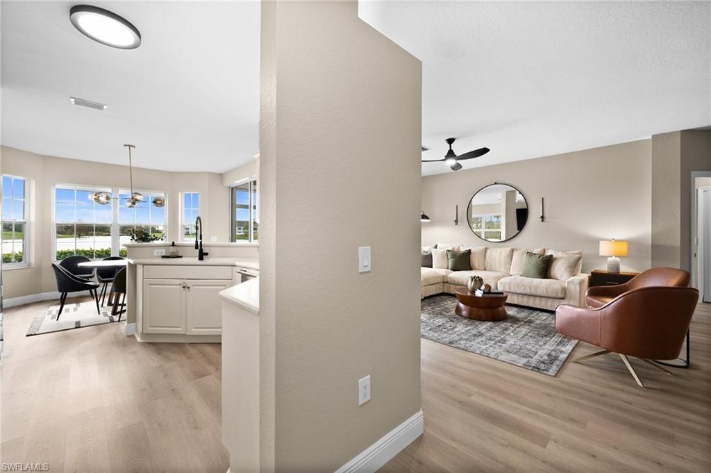 6080 Pinnacle Lane, Unit 1701 Naples, FL 34110 - Photo 5 of 39 a living room with furniture and a wooden floor