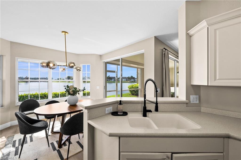 6080 Pinnacle Lane, Unit 1701 Naples, FL 34110 - Photo 7 of 39 a kitchen with a sink and a large window
