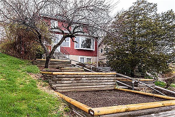 59 Coolidge Road Arlington, MA 02476 - Photo 2 of 22 a view of a yard with plants and a fire pit