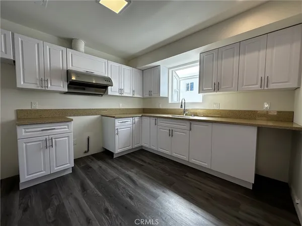a kitchen with sink cabinets and window