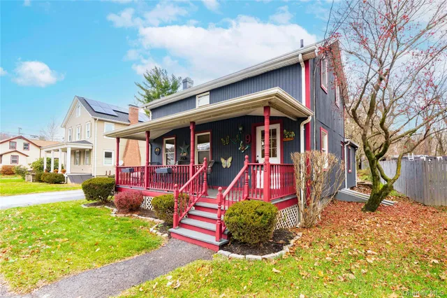 a view of a house with a yard patio and fire pit