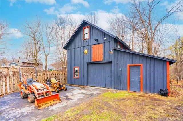 an empty room with windows and fireplace