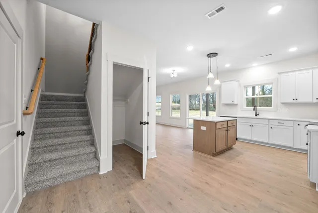 a view of kitchen with sink microwave and refrigerator
