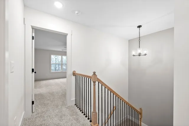 a view of a hallway with windows and stairs