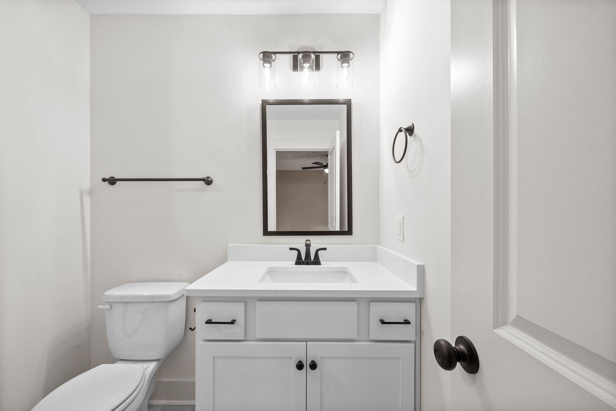 193 Dewberry Road Clarksville, TN 37042 - Photo 22 of 30 a bathroom with a toilet a sink and mirror