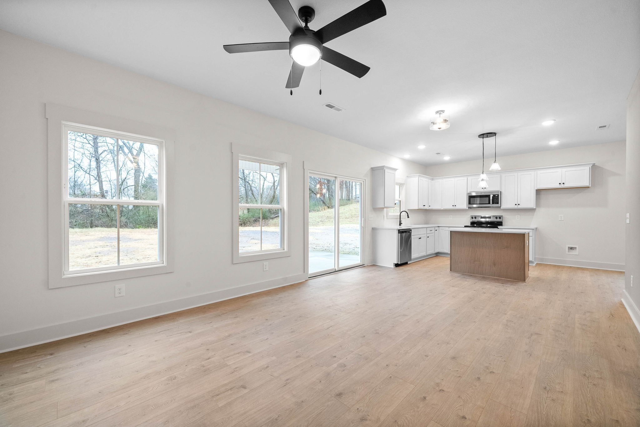 193 Dewberry Road Clarksville, TN 37042 - Photo 5 of 30 a view of a kitchen with kitchen island a sink stainless steel appliances and a chandelier