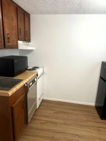 a bathroom with a sink and mirror with toilet