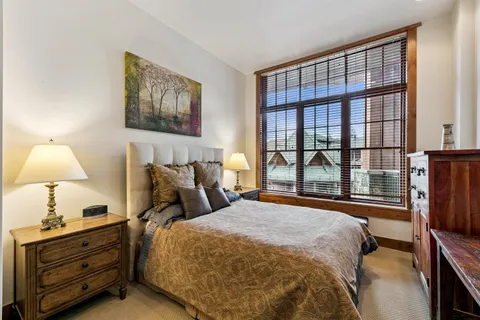 a bed sitting in a bedroom next to a window