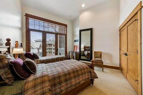 a bedroom with a bed and a large window