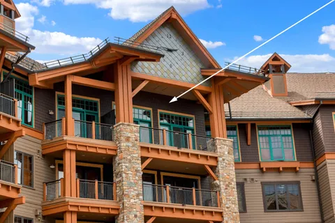 a front view of a residential apartment building with a yard