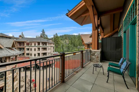 a view of a chairs and table in the balcony