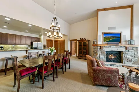 a view of a dining room with furniture a chandelier and wooden floor