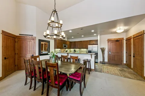 a view of a dining room with furniture and chandelier