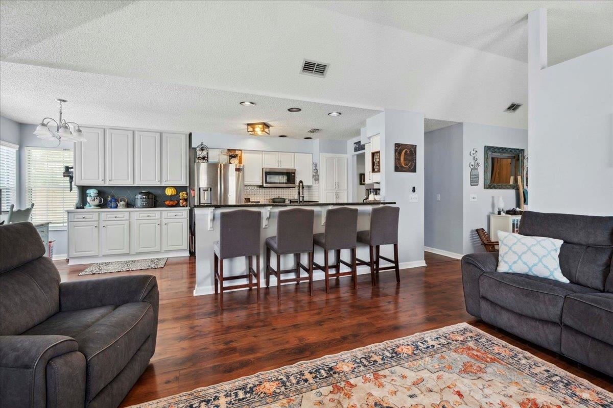 536 Moultrie Wells Road St. Augustine, FL 32086 - Photo 11 of 40 a living room with furniture wooden floor and kitchen view