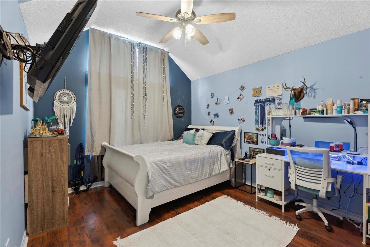 536 Moultrie Wells Road St. Augustine, FL 32086 - Photo 17 of 40 a bedroom with a bed and a chandelier