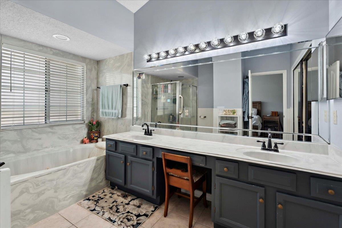 536 Moultrie Wells Road St. Augustine, FL 32086 - Photo 20 of 40 a bathroom with a double vanity sink mirror and bathtub