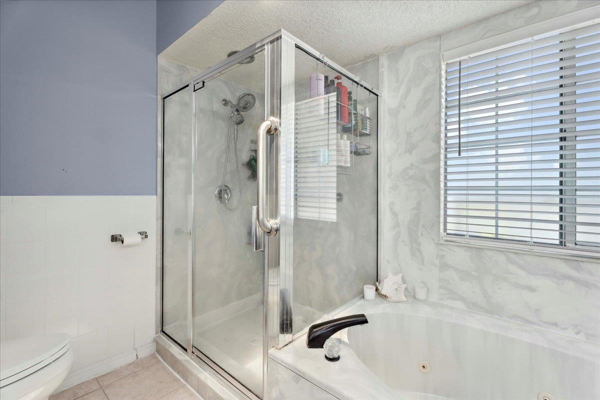 536 Moultrie Wells Road St. Augustine, FL 32086 - Photo 21 of 40 a bathroom with a bathtub and a shower